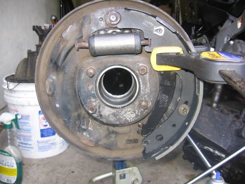 1989 Ford Bronco - The brake drum assembly is shown with new brake shoes and a wheel cylinder, indicating maintenance work.