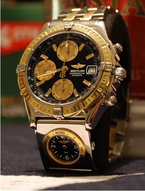 1998 Ford Crown Victoria - This Breitling Chronometre Automatic watch features a two-tone metal band, gold bezel, and a black dial with gold sub-dials.
