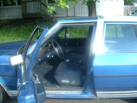 1987 Ford Crown Victoria LTD - Interior view of a blue 1987 Ford Crown Victoria LTD, showing the driver's seat and dashboard.