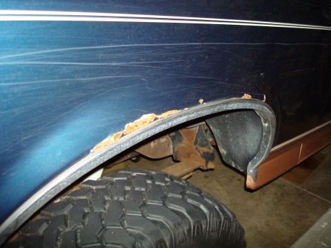 1995 Ford Bronco - Close-up of rust forming on the wheel well of a 1995 Ford Bronco.