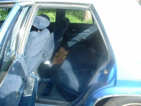 1987 Ford Crown Victoria LTD - Interior view of a 1987 Ford Crown Victoria LTD, showing the blue velour seating and door panels.