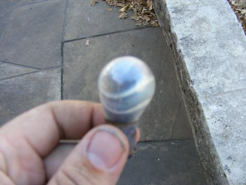 1979 Ford Bronco - A chrome gear shift knob with a swirling pattern is held in a hand.