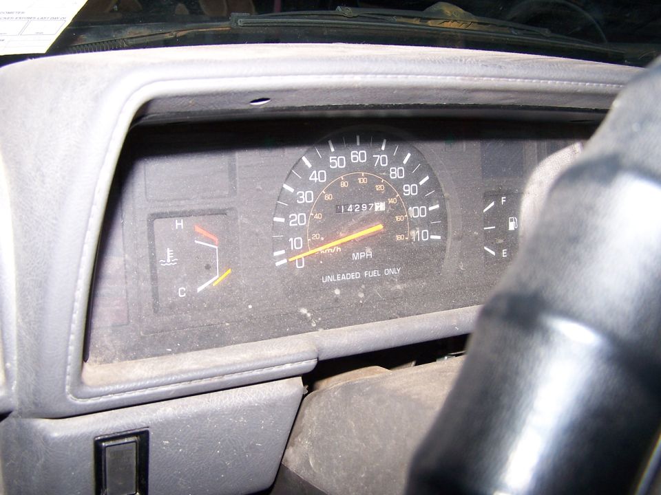 Speedometer reads 14297 miles, temp gauge is near C, fuel gauge is near E