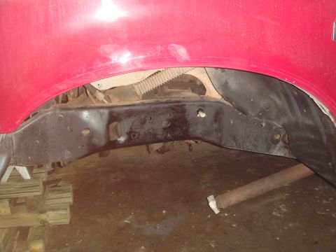 1992 Ford Bronco - The underside of a vehicle shows the frame, suspension components, and a portion of the exhaust system.