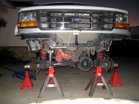 1996 Ford Bronco - Front suspension of a 1996 Ford Bronco is raised on jack stands for maintenance.