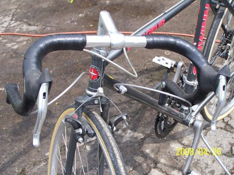 1988 Toyota Pickup/SR5 - Two bicycles are parked outdoors, with a close-up view of the handlebars and front wheel of one.