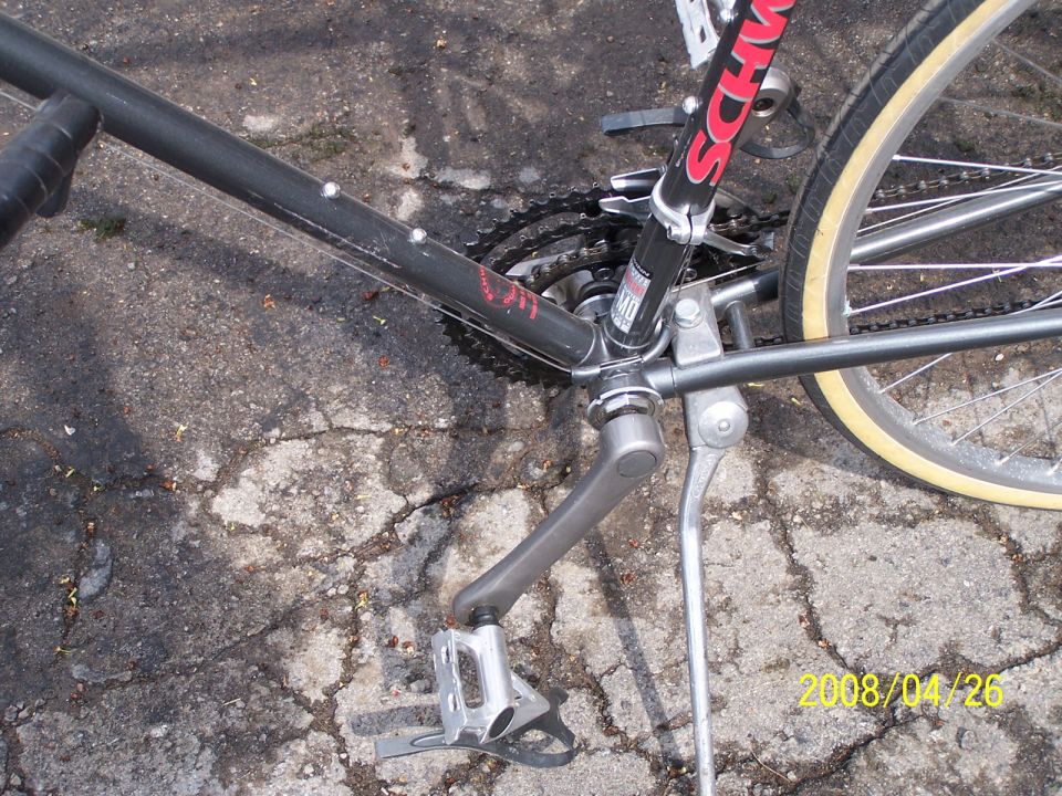 Black bicycle frame with Schwinn logo, crankset, and rear wheel
