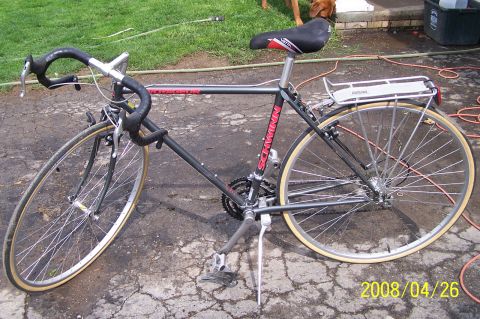 1988 Toyota Pickup/SR5 - A black Schwinn bicycle is shown from the side, with a rear rack and drop handlebars.