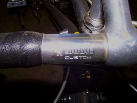 1988 Toyota Pickup/SR5 - Engraved 'SAKAE CUSTOM' on bicycle handlebars, part of a bicycle.