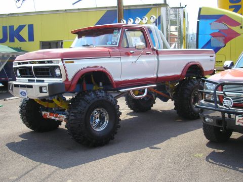 1995 Ford Bronco - This heavily modified Ford pickup truck features a two-tone paint scheme and an extreme lift kit.