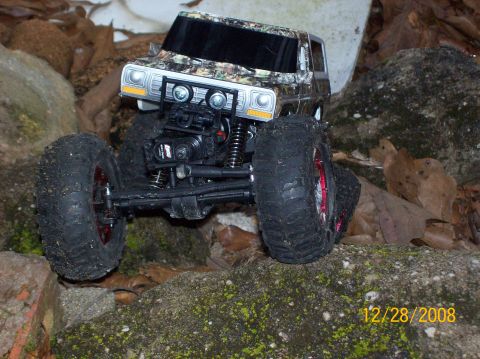 1978 Ford Bronco - RC rock crawler toy truck with camouflage pattern on body, large tires, and front winch.