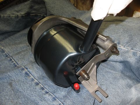 1968 Shelby GT500 - A power steering cylinder, likely for a classic car, is shown with its mounting bracket and hose.