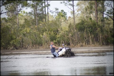 1996 Ford F-150 - Jet ski stuck in mud with a rider attempting to move forward.