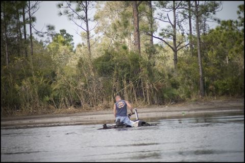 1996 Ford F-150 - A man is sitting on an ATV that is mostly underwater in a wooded area.