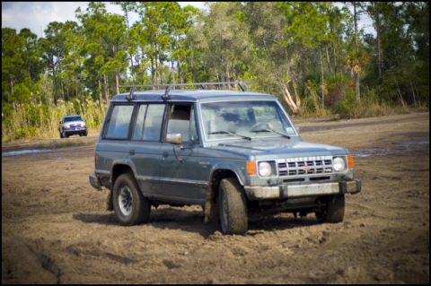1996 Ford F-150 - Mitsubishi Montero off-road with a second vehicle visible in the distance.