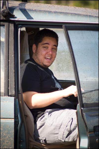 1996 Ford F-150 - A man is seated in the driver's seat of a vehicle with the door open.