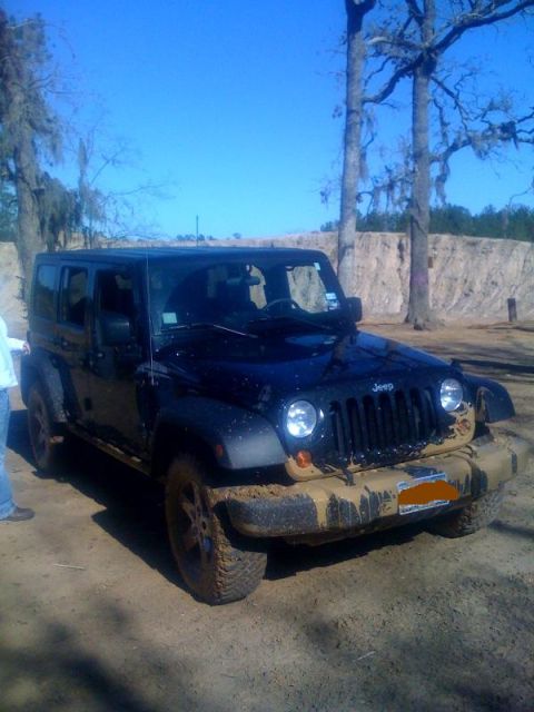 2008 Jeep Wrangler - This black Jeep Wrangler appears to have recently been off-roading, as it is heavily covered in mud.