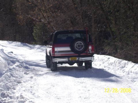 1993 Ford Bronco - A red and white Ford Bronco navigates a snowy path on December 28, 2008.