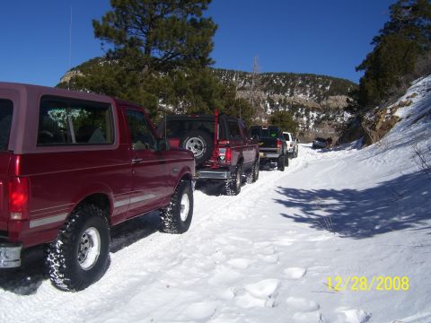 1993 Ford Bronco - Multiple vehicles drive in a line on a snowy mountain road on December 28, 2008.