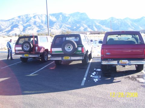 1993 Ford Bronco - Three SUVs are parked in a lot with snow on the ground and mountains in the distance. The photo is dated 12/28/2008.