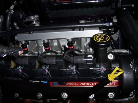 2007 Ford Mustang - Close-up of a Ford SVT engine, showing fuel injectors and ignition system components.