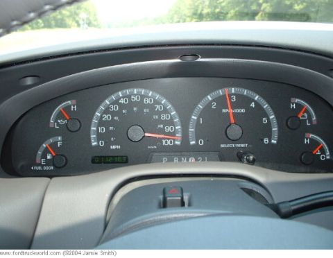 2007 Ford Mustang - The dashboard gauges show the vehicle's speed, RPM, fuel level, and oil pressure. The odometer displays 112,169 miles.