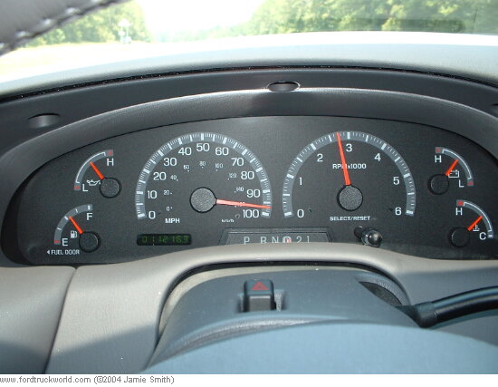 Dashboard gauges with speedometer, tachometer, fuel, and oil indicators. Odometer reads 011216.9