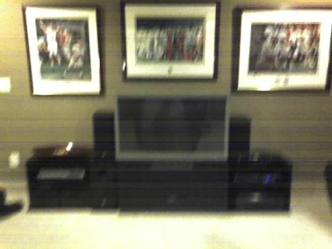 1996 Ford Bronco - A home entertainment setup features a large television, audio equipment, and framed artwork displayed on the wall.
