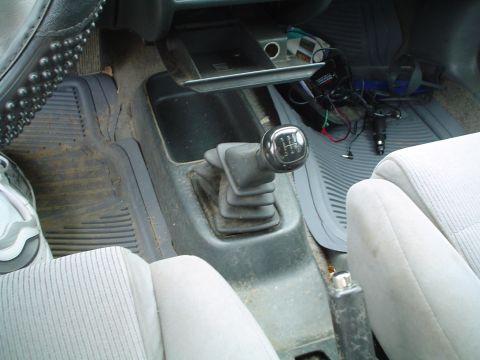 1989 Mercury Topaz - Interior view of a car's center console, showing the gear shifter and surrounding floor area.