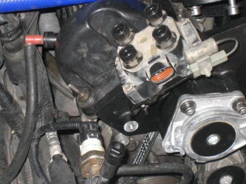 1996 Ford Thunderbird - A close-up view of the engine bay of a 1996 Ford Thunderbird, focusing on the intake manifold and various sensors and hoses.