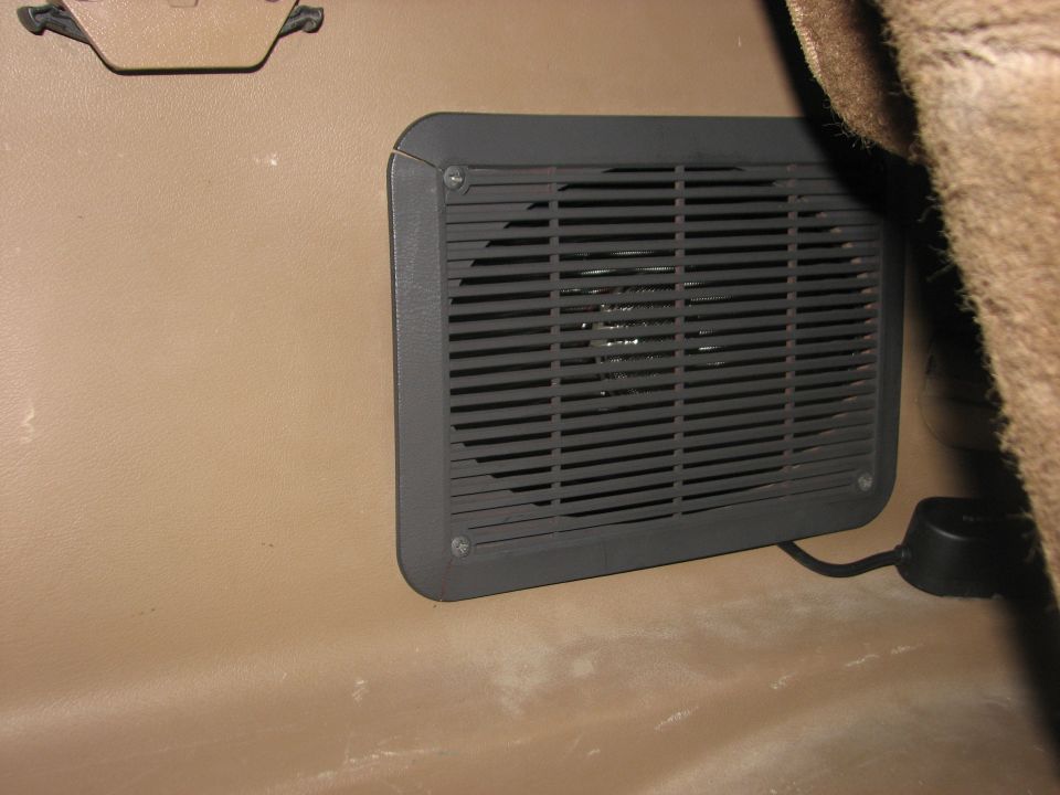 Vehicle interior speaker grille with attached cable