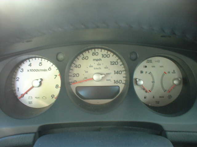 Cream-faced three-pod gauge cluster with 9000 rpm tach and 160 mph speedometer