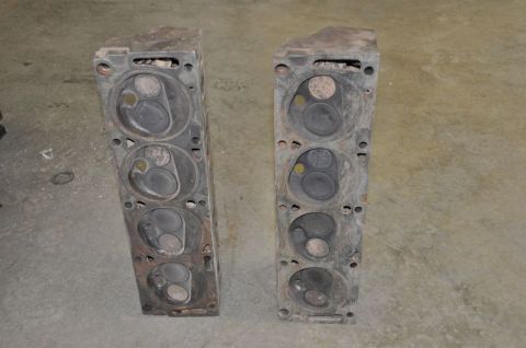 1996 Ford Bronco - A pair of used engine cylinder heads are shown, likely removed from a vehicle for repair or replacement.