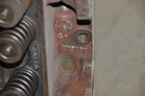1996 Ford Bronco - Close-up of a corroded engine component, showing stamped markings and valve springs.