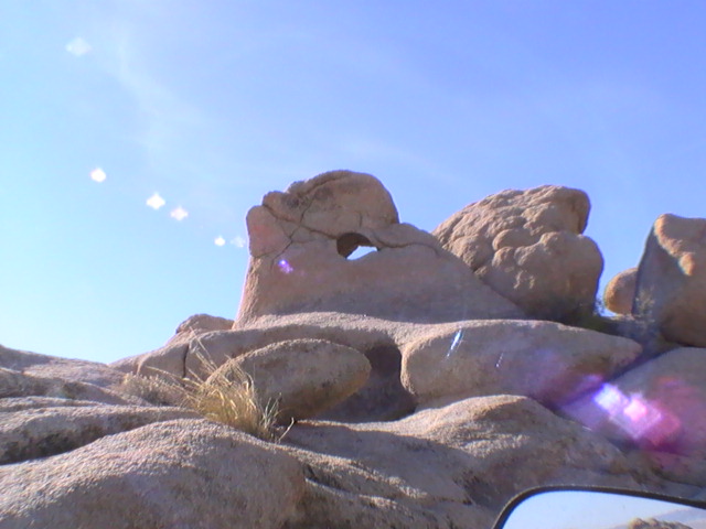 Rock formation with a hole against a blue sky