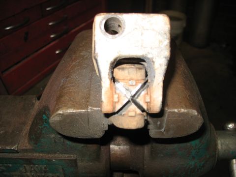 1978 Ford Bronco - A close-up view of a steering column component secured in a vise, showing internal mechanical details.