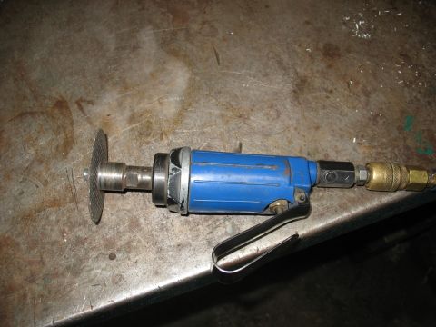 1978 Ford Bronco - A blue air-powered cut-off tool with a metal cutting disc is shown on a workbench.
