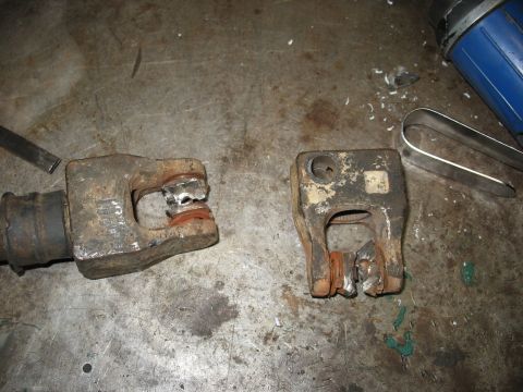 1978 Ford Bronco - Damaged steering column components resting on a metal workbench surface.