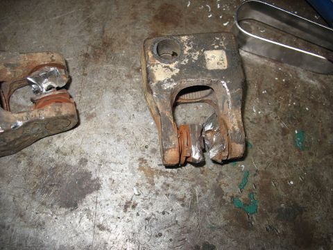 1978 Ford Bronco - Close-up of a damaged steering column component, showing signs of wear and tear on a workbench.