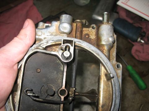 1978 Ford Bronco - Close-up view of a carburetor component being held by a person's hand.