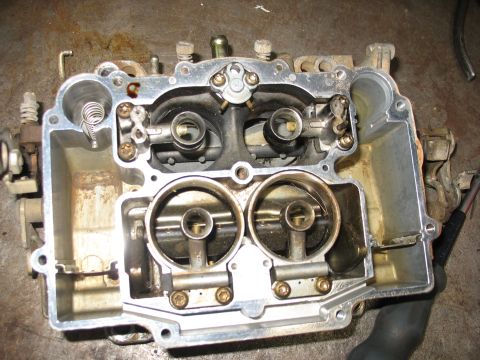 1978 Ford Bronco - A disassembled carburetor, likely for an older vehicle, is shown from a top-down perspective.