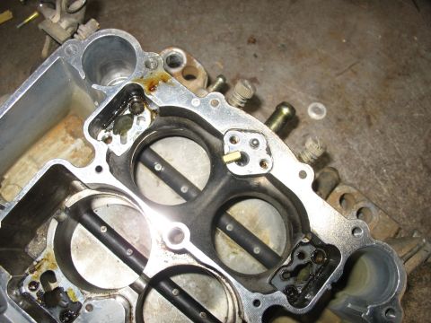 1978 Ford Bronco - A close-up view of a carburetor's internal workings, showing the throttle plates and fuel passages.