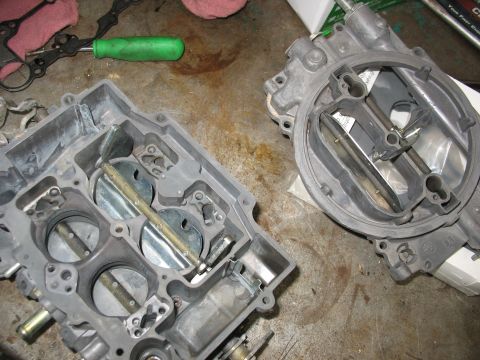1978 Ford Bronco - Disassembled carburetor components are laid out on a workbench, ready for cleaning or repair.