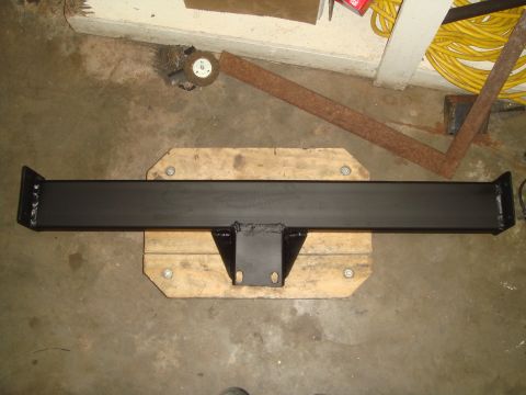 1992 Ford Bronco - A black steel trailer hitch receiver is shown mounted on wooden blocks, likely in a garage or workshop setting.