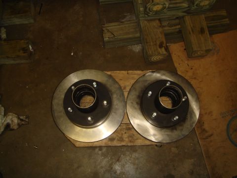1992 Ford Bronco - A pair of vehicle brake rotors are shown resting on wooden planks.