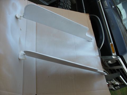 1978 Ford Bronco - Interior view of a 1978 Ford Bronco, showing two white sun visors being worked on.