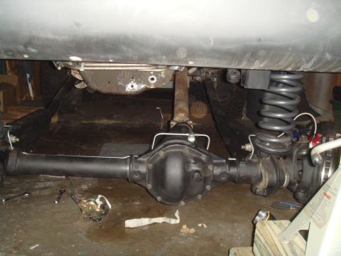 1992 Ford Bronco - Underside view of a vehicle's rear axle and suspension system, showing mechanical components.