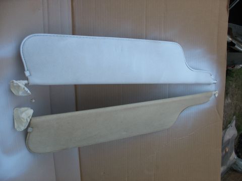 1978 Ford Bronco - Two sun visors, one in white and the other in beige, are laid out on a cardboard surface.