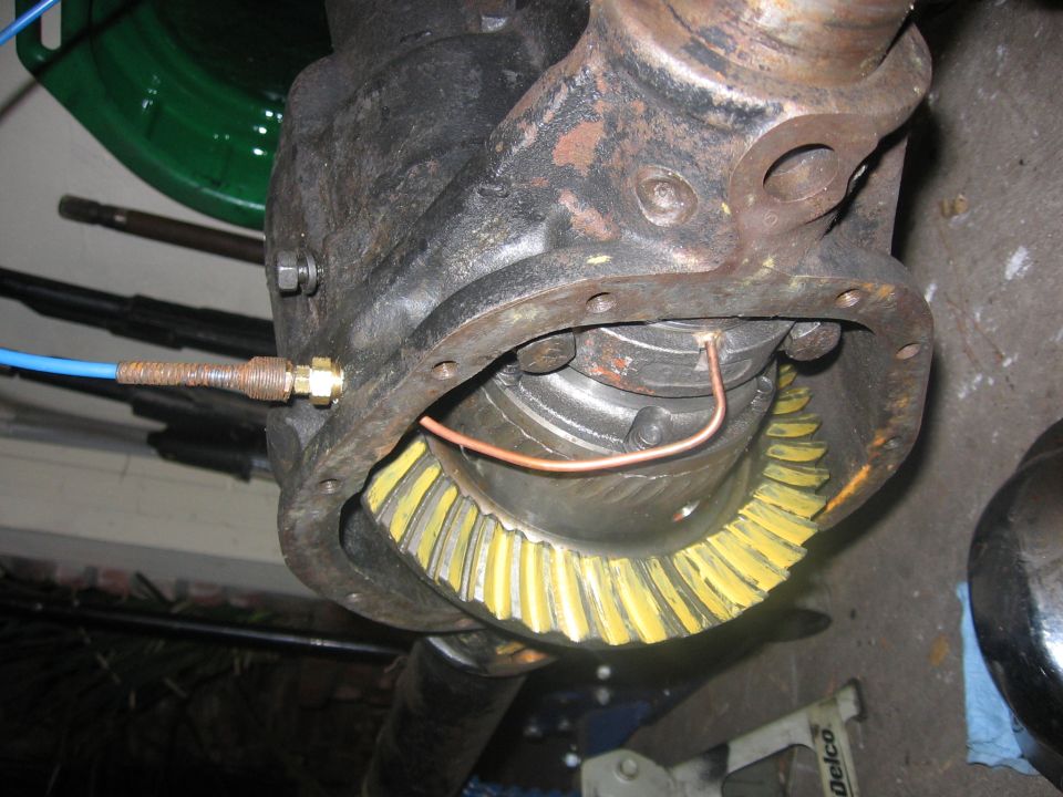 Differential ring-and-pinion gear inside a rusty axle housing