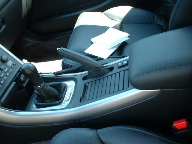 Black leather car interior with manual shifter, handbrake and center console